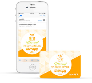 A smartphone displays an email from Quarks with a gift card image. The card reads, "Treat Yourself To Some Retail Therapy," and a physical card with the same design is next to the phone.