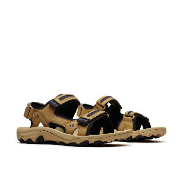 Pair of tan and black sandals with velcro straps and ridged soles.