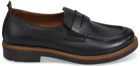 A black leather penny loafer shoe with a brown welt and a thick black sole.