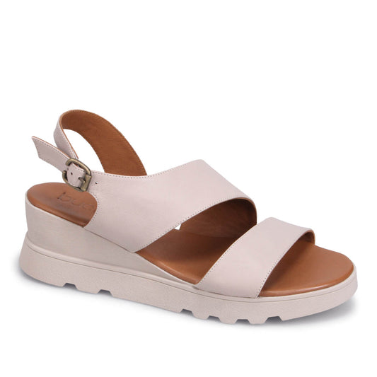Off-white sandal with two straps and a buckle.