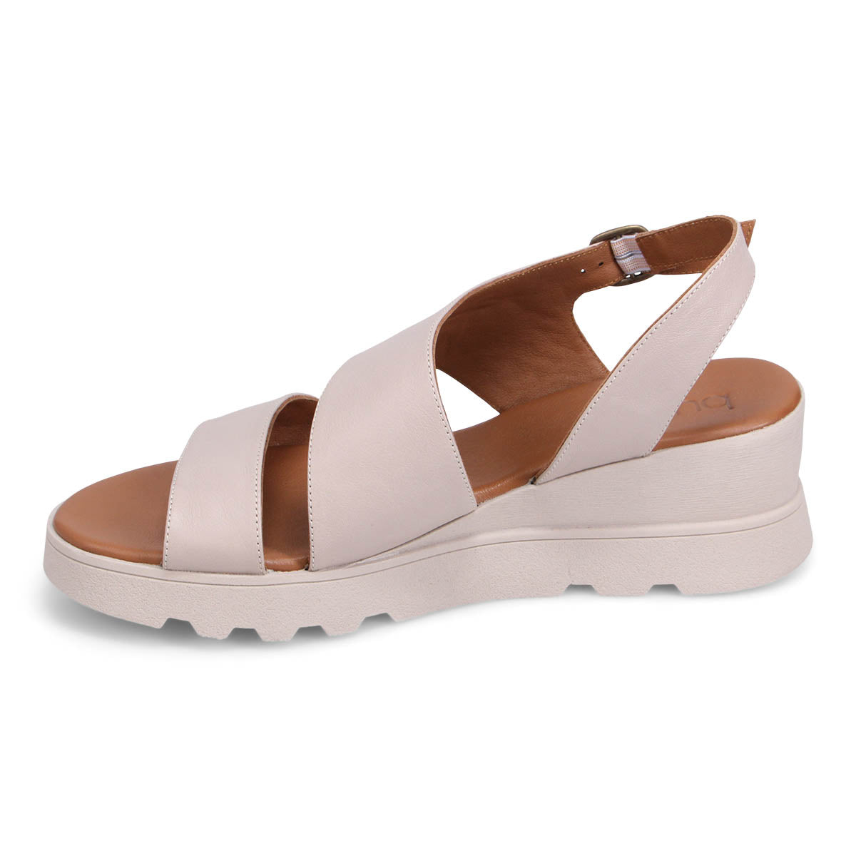 Side view of a cream-colored, wedge heeled sandal with criss-cross straps and a buckle ankle strap.