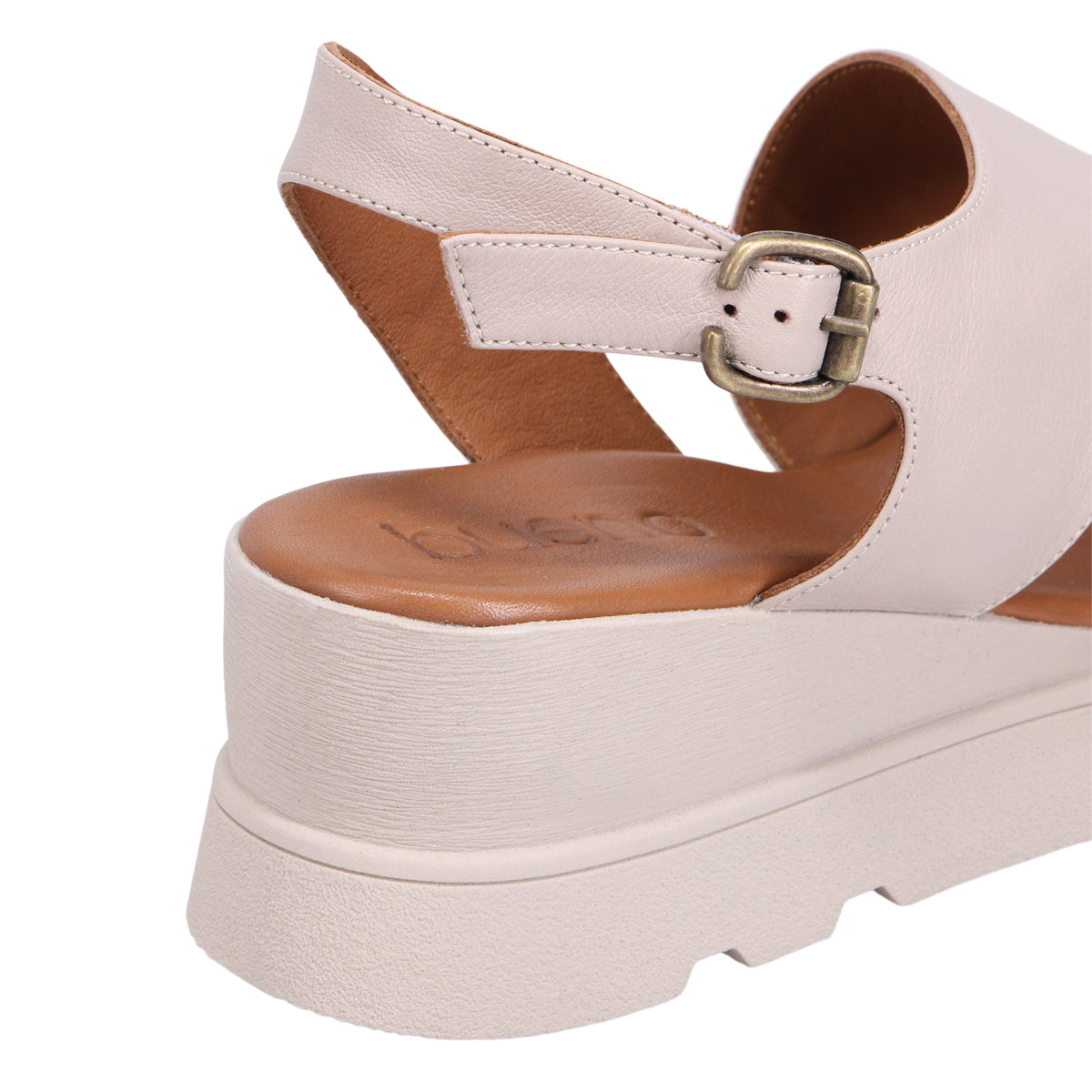 Cream-colored, open-toed platform sandal with buckled strap.