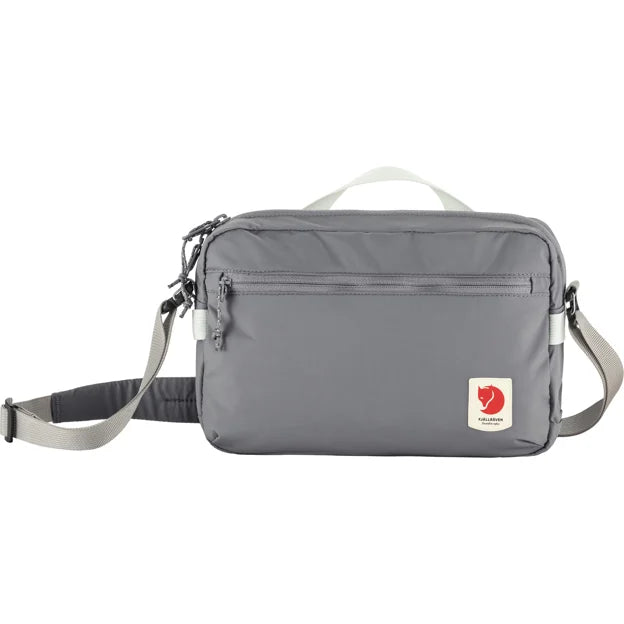 Gray messenger bag with a gray strap and a white handle.