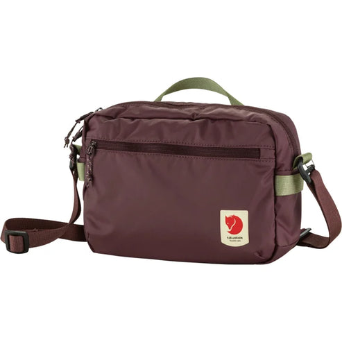 Maroon messenger bag with a front pocket and carrying handles.