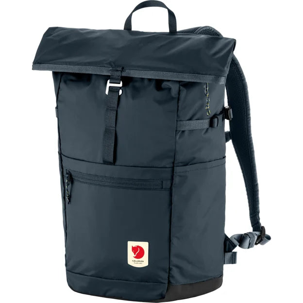 A navy backpack with a top flap closure, a buckle, a zipper pocket, a handle, adjustable shoulder straps, and a red and white logo patch.