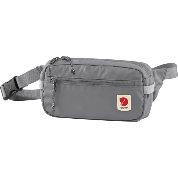 Gray rectangular waist bag with front zipper pocket and logo patch.