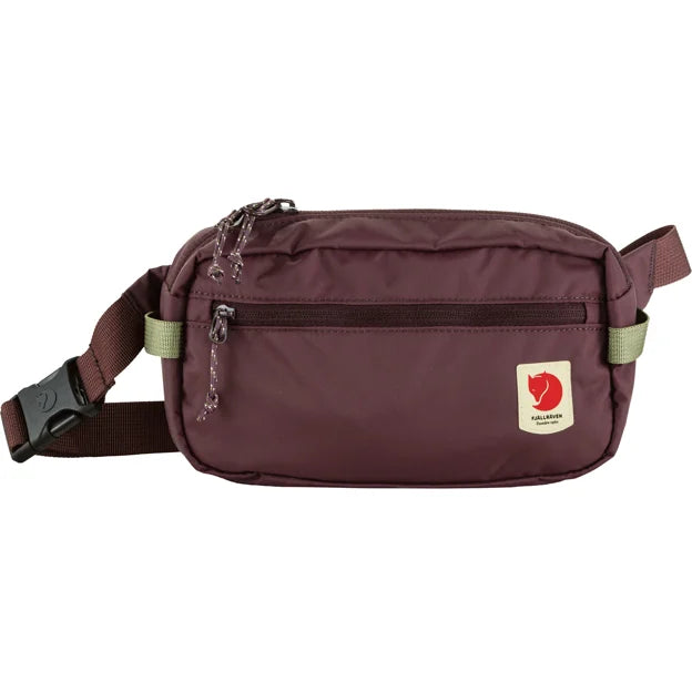 Maroon waist bag with front zipper pocket and logo patch.