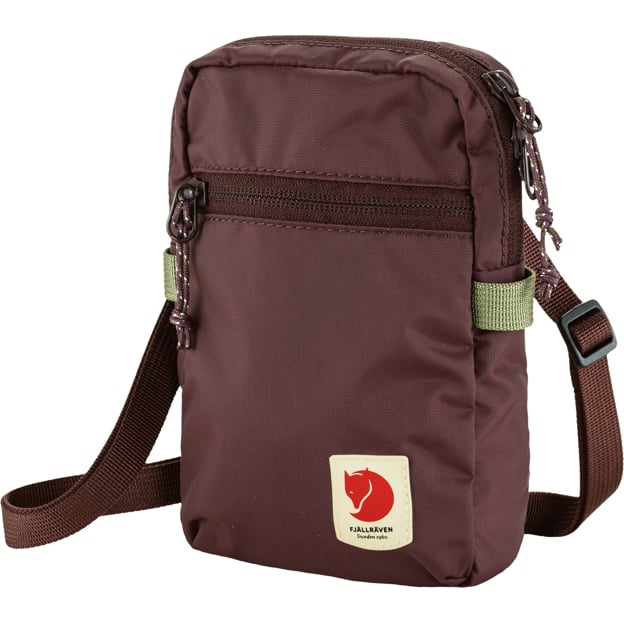 Small maroon Fjallraven shoulder bag with adjustable brown strap, zipper compartments and logo.