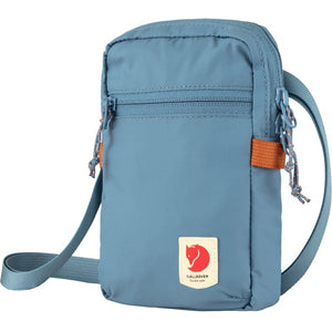 A blue Fjallraven sling bag with zipper closure and shoulder strap.