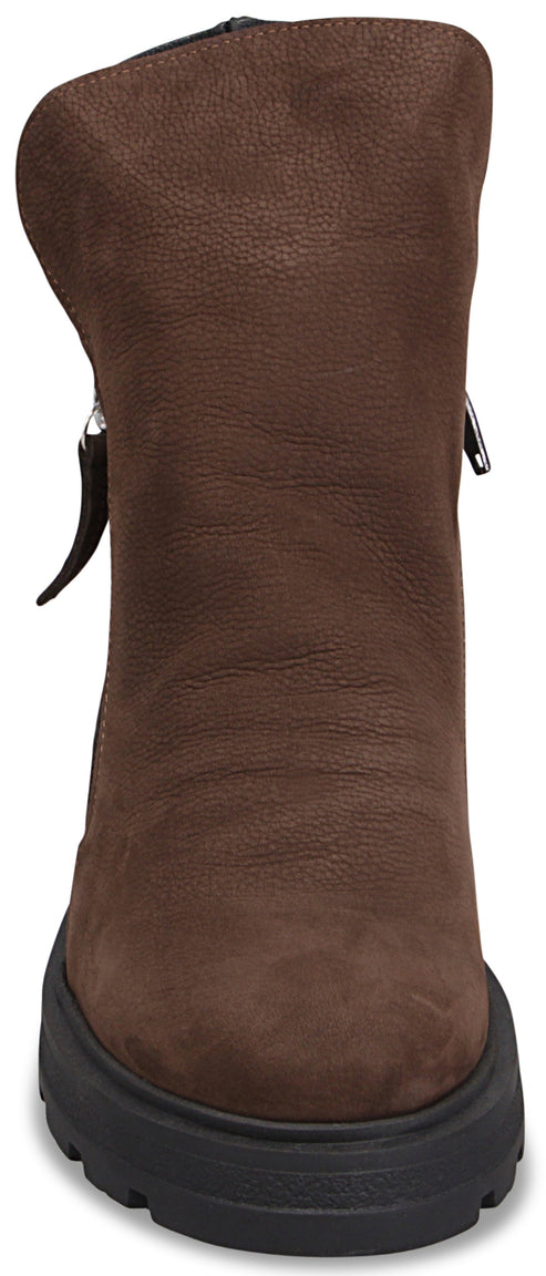 A brown faux suede mid-calf boot with a thick black lug sole, viewed from the front, featuring silver side zippers.