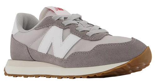 Low-top athletic shoe, gray suede panels on a light gray nylon base, white N logo, gum sole.