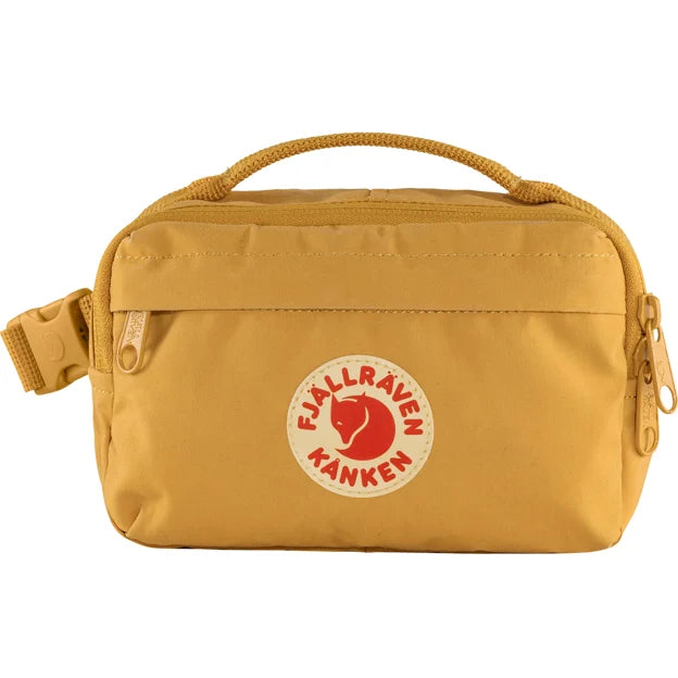 Golden-yellow waistpack featuring the iconic red and white circular logo with an arctic fox at the center and a buckled strap.