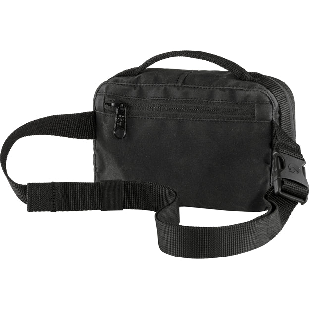 A black fabric fanny pack with a top handle and a zipped front pocket.