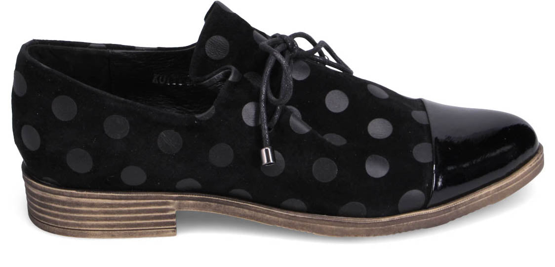 A black, polka-dotted, lace-up oxford shoe with a patent leather toe.