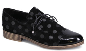 Black polka-dotted flat shoe with patent leather toe and lace-up closure.