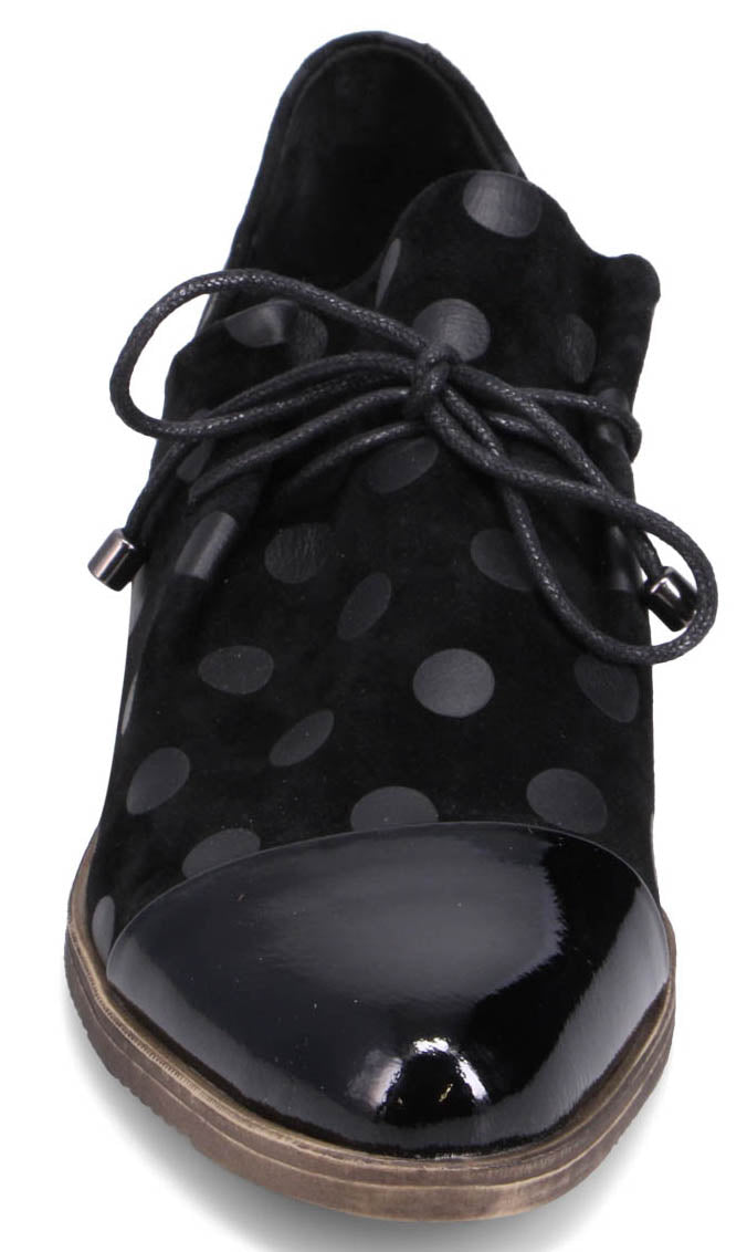 Black leather shoe with a rounded glossy toe cap, laces and polka dots.