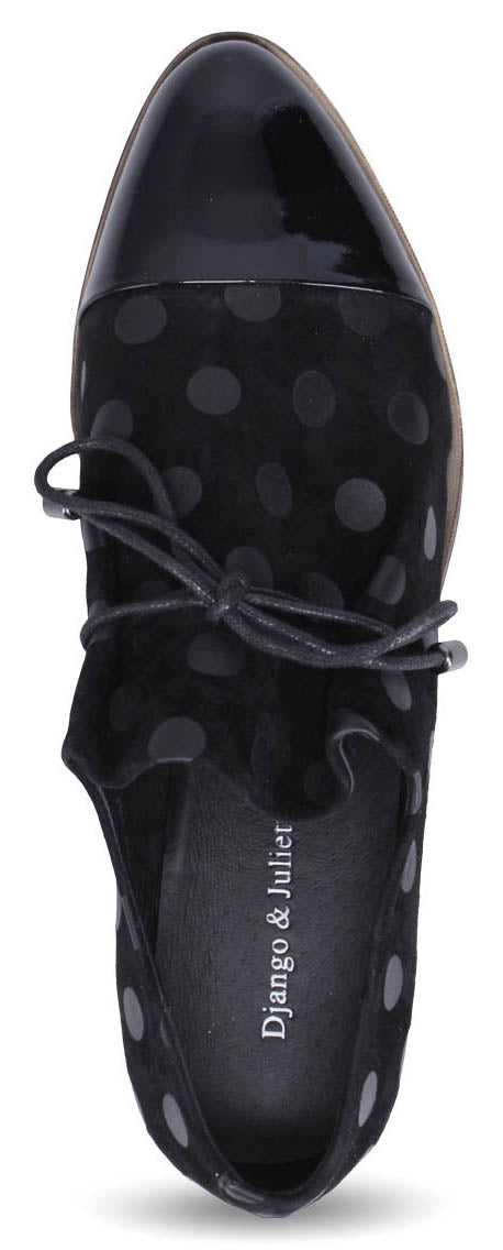 A black women's shoe with a polka dot design and black shoe laces.