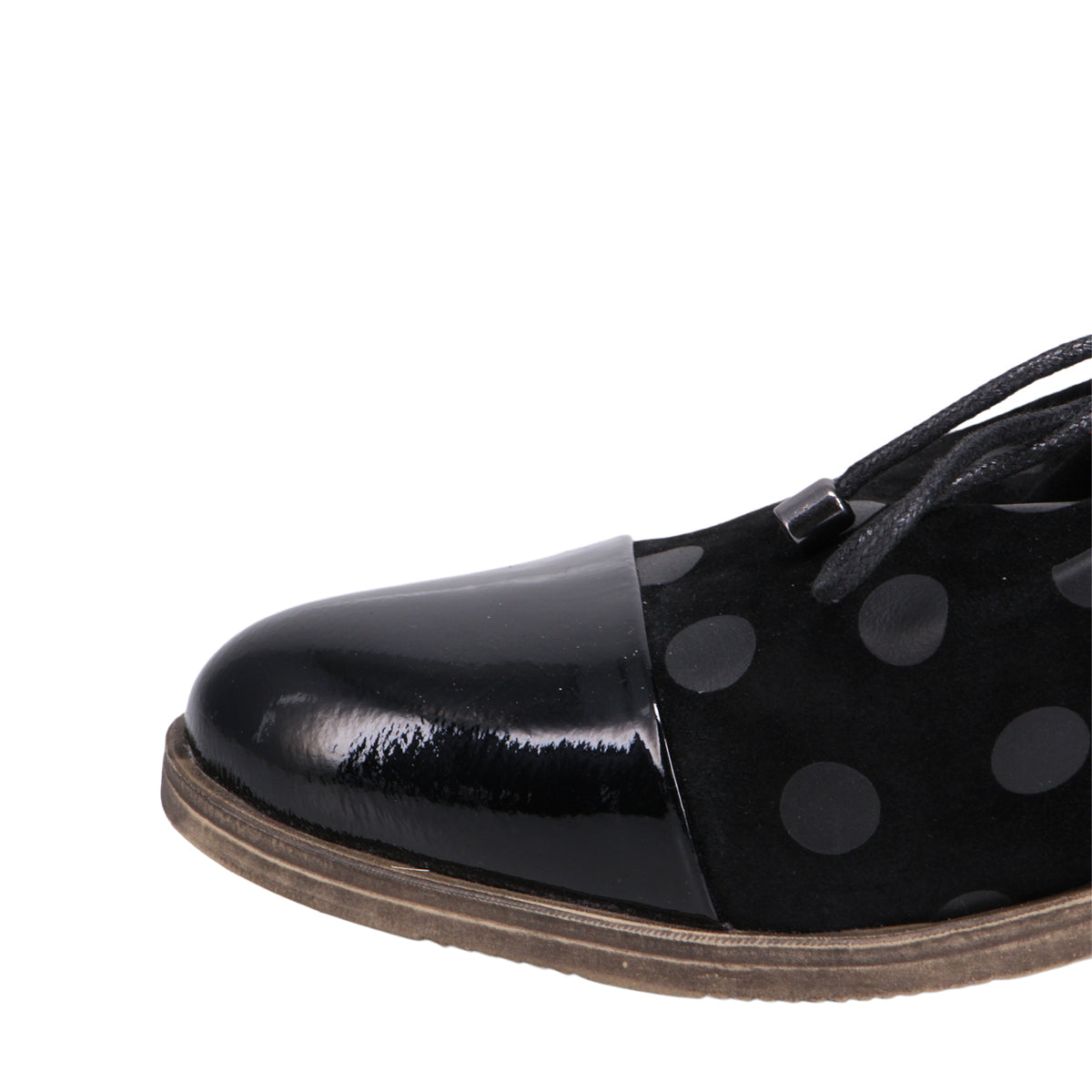 Close-up of a black dress shoe with a shiny black cap toe and polka dot design.