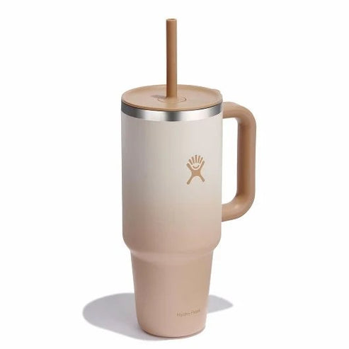 Tall beige and white insulated mug with handle and straw.