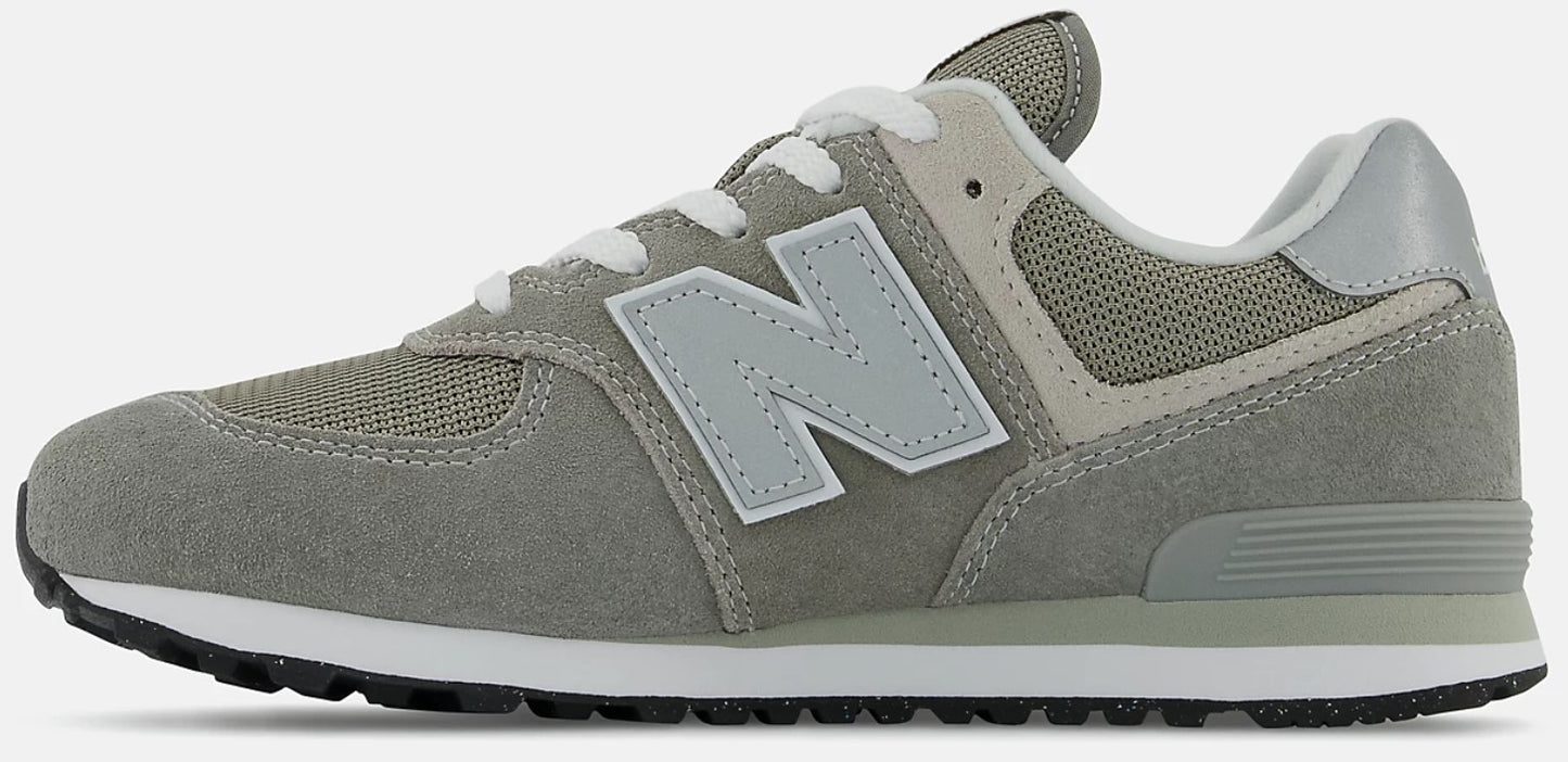 a gray and white athletic shoe with a large 'N' logo