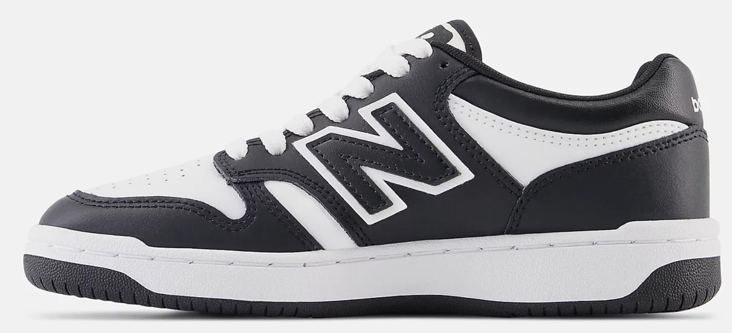 A New Balance shoe, black with white accents, featuring the New Balance "N" logo in white.