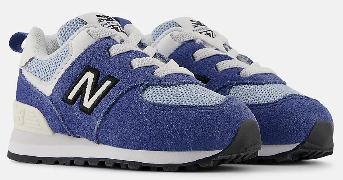 A pair of low-top blue sneakers with white laces and black and white logo on the side.