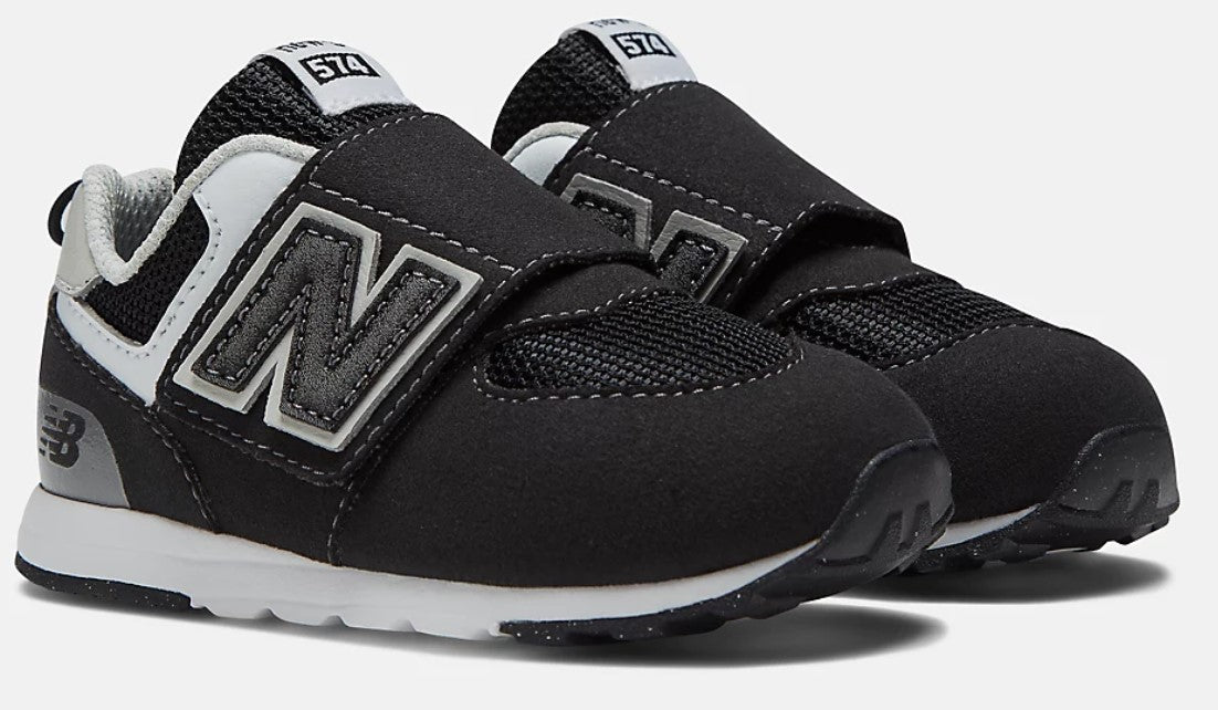 Toddler black shoes with velcro straps, white soles and gray 'N' logo.