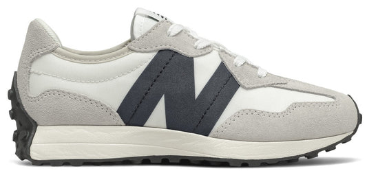 A low-top sneaker with a white canvas upper, grey suede overlays, a black "N" logo, and a black outsole.