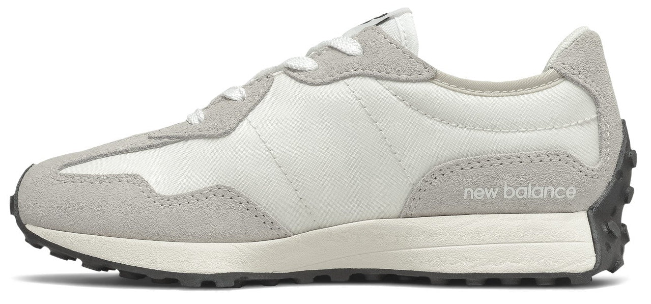 A white and grey sneaker with the words "new balance" printed on the side.