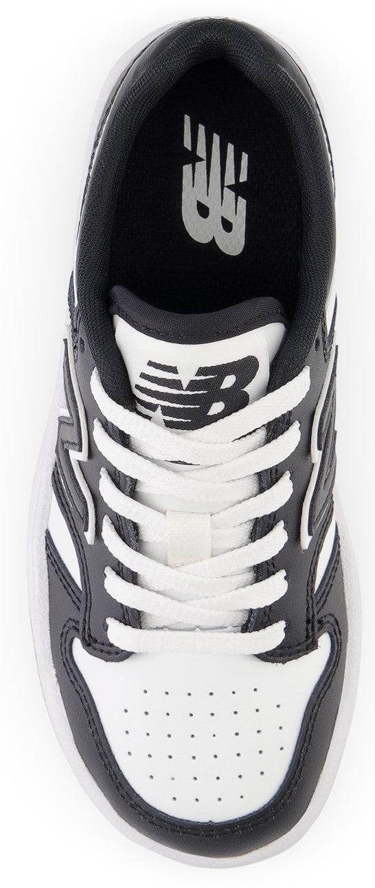 A top-down view of a black and white athletic shoe with white laces.