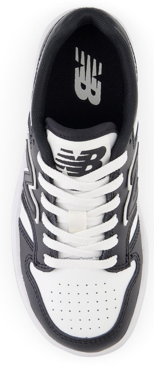 A top-down view of a black and white athletic shoe with white laces.