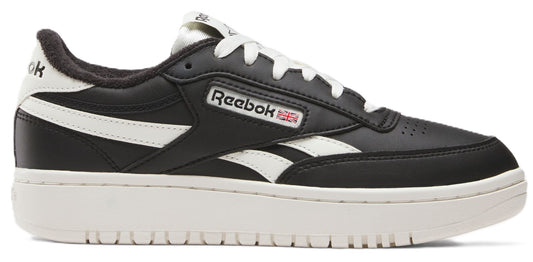 A black and white low-top sneaker with a thick, white sole and laces.