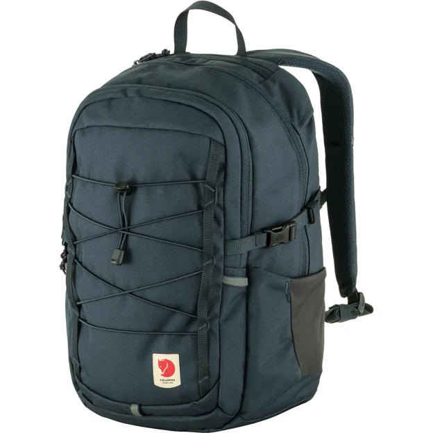 Dark blue backpack with drawstring and logo patch, showing straps, handle, side pocket, and buckle.