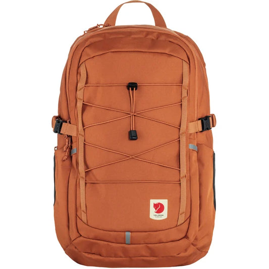 Orange backpack with a bungee cord design on the front.