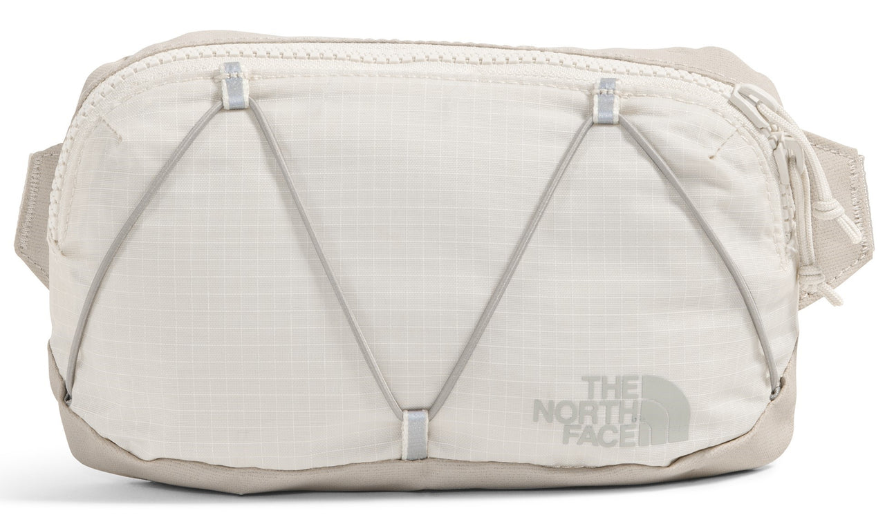 Bone white waist bag with bungee cord front detail and 'THE NORTH FACE' logo.