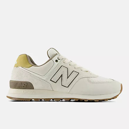 Off-white sneaker with an "N" logo, a suede heel panel, brown accents, and a gum sole.
