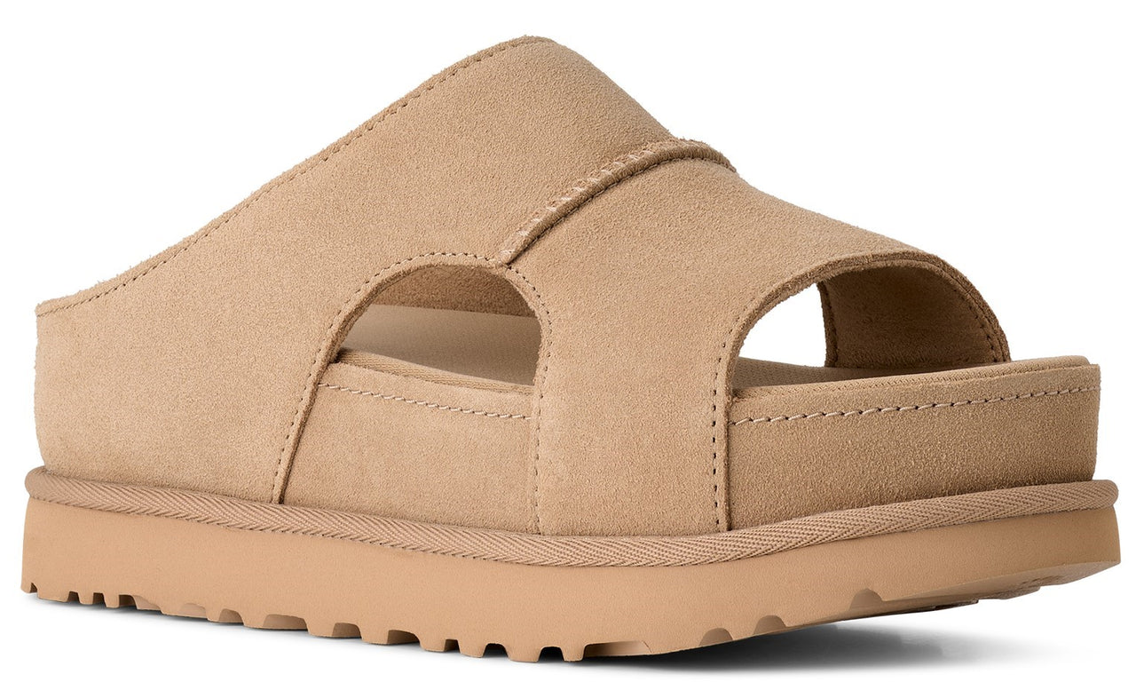 Tan-colored sandal with thick sole and top strap.