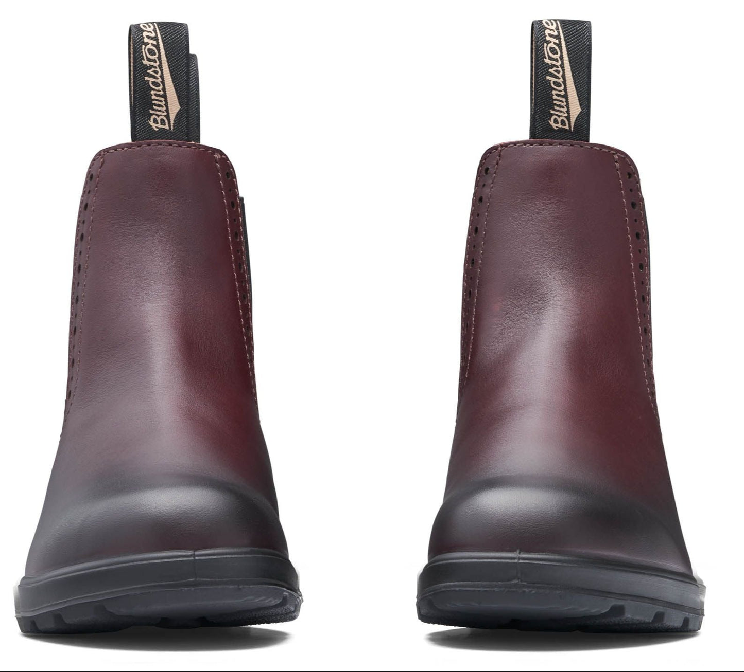 Pair of ankle-high reddish-brown Chelsea boots with black pull loops and black soles.