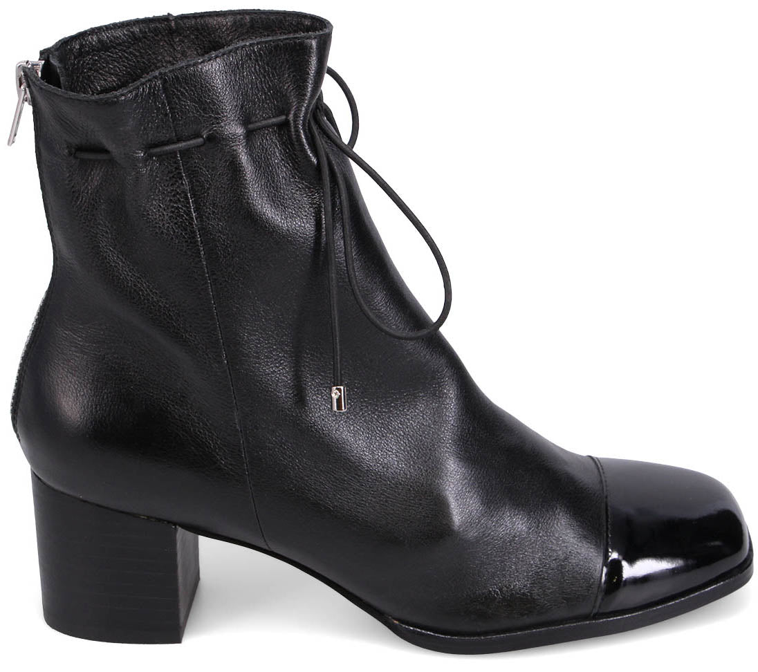 Black leather ankle boot with a block heel, square toe with patent leather detail, and drawstring closure.