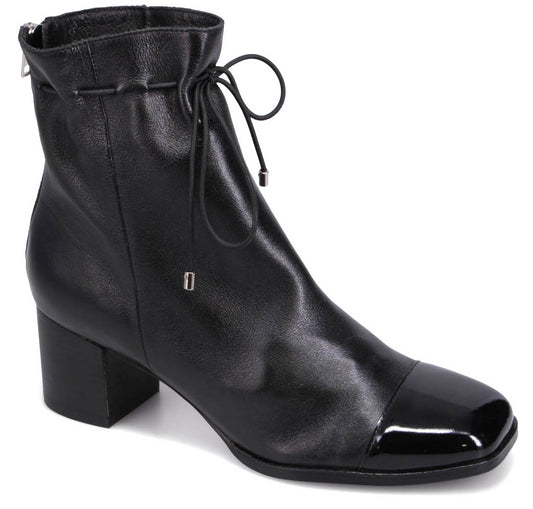 Black ankle boot with a square, patent-leather toe, gathered topline, and block heel.