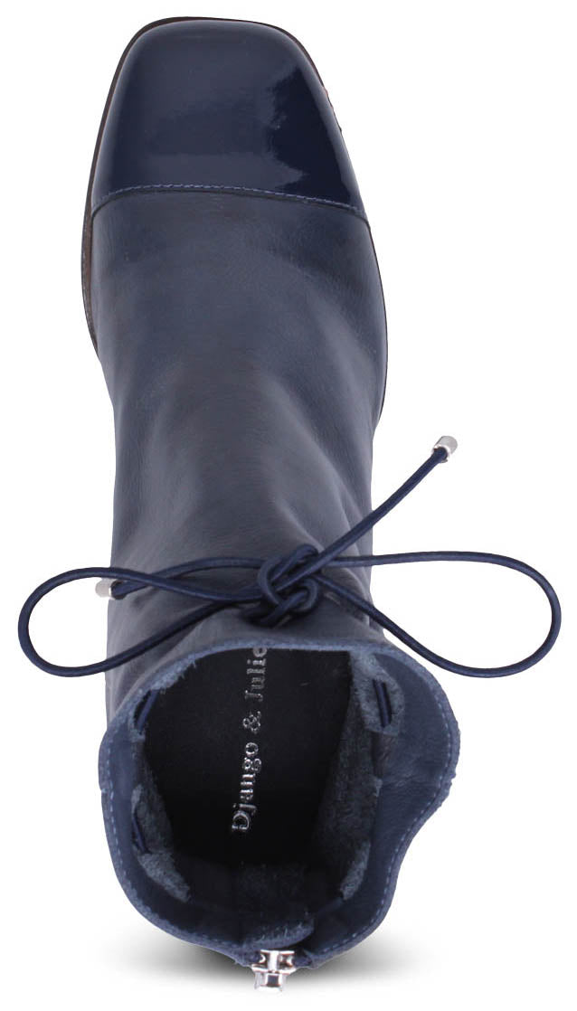 A top view of a blue leather heeled boot with a square toe, lace up front and a zipper back. Inside the boot reads "Django & Juliette".