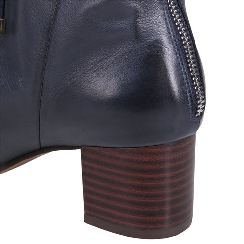 Close-up of navy leather bootie with block heel and back zipper.