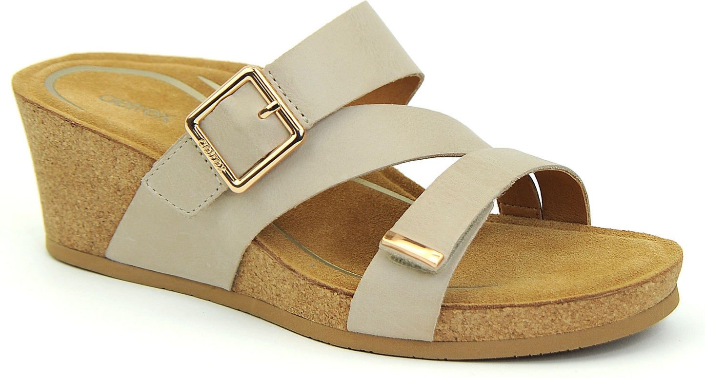 Beige wedge sandal with adjustable buckle strap and cross straps.