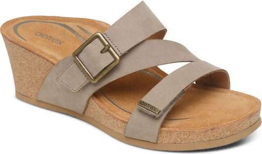 Beige slide sandals with a buckle and two straps.