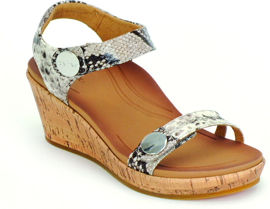 Wedge sandal with cork sole and snake print straps secured by metal buttons.