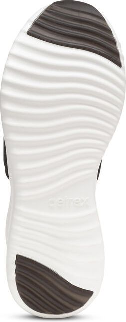 A white shoe sole with black textured rubber on the toe and heel.