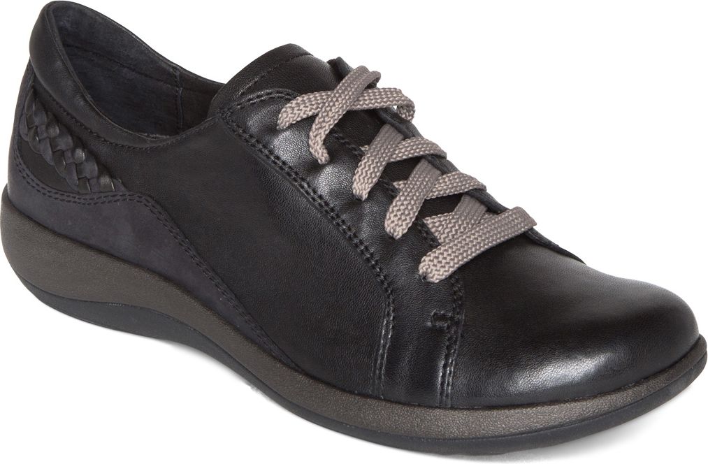 A black leather women's casual sneaker with gray shoelaces and a braided heel.