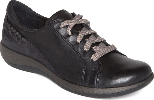A black leather women's casual sneaker with gray shoelaces and a braided heel.