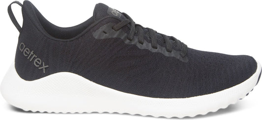 Black sneaker with white sole and 'aetrex' text on the side.