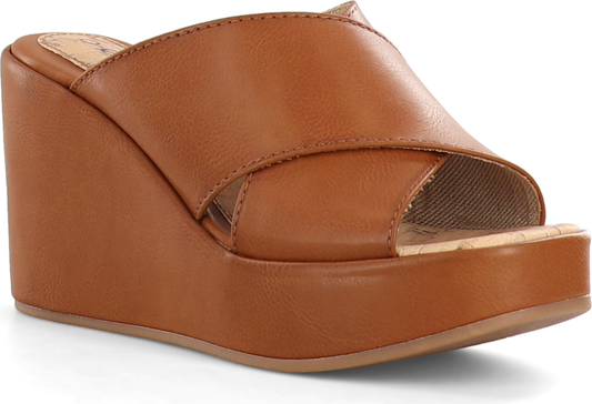 A brown wedge sandal with a crossover strap.
